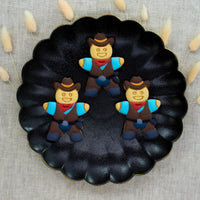 cowboy cookies colored with royal icing made with bakerlogy gingerbread cowboy cookie cutter