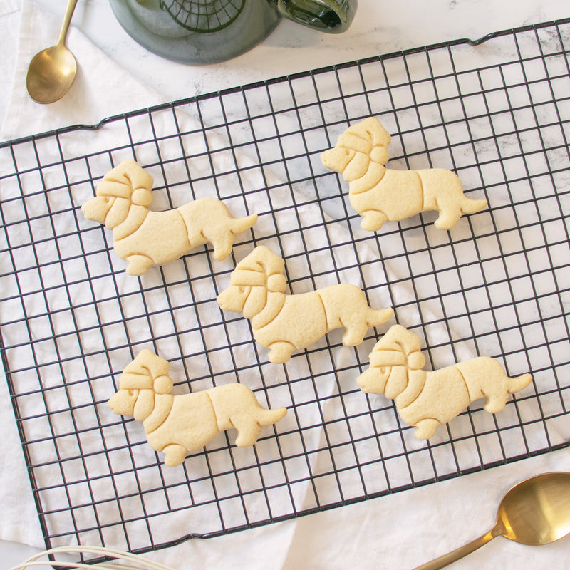 bakerlogy christmas dachshund sugar cookies on a cooling rack
