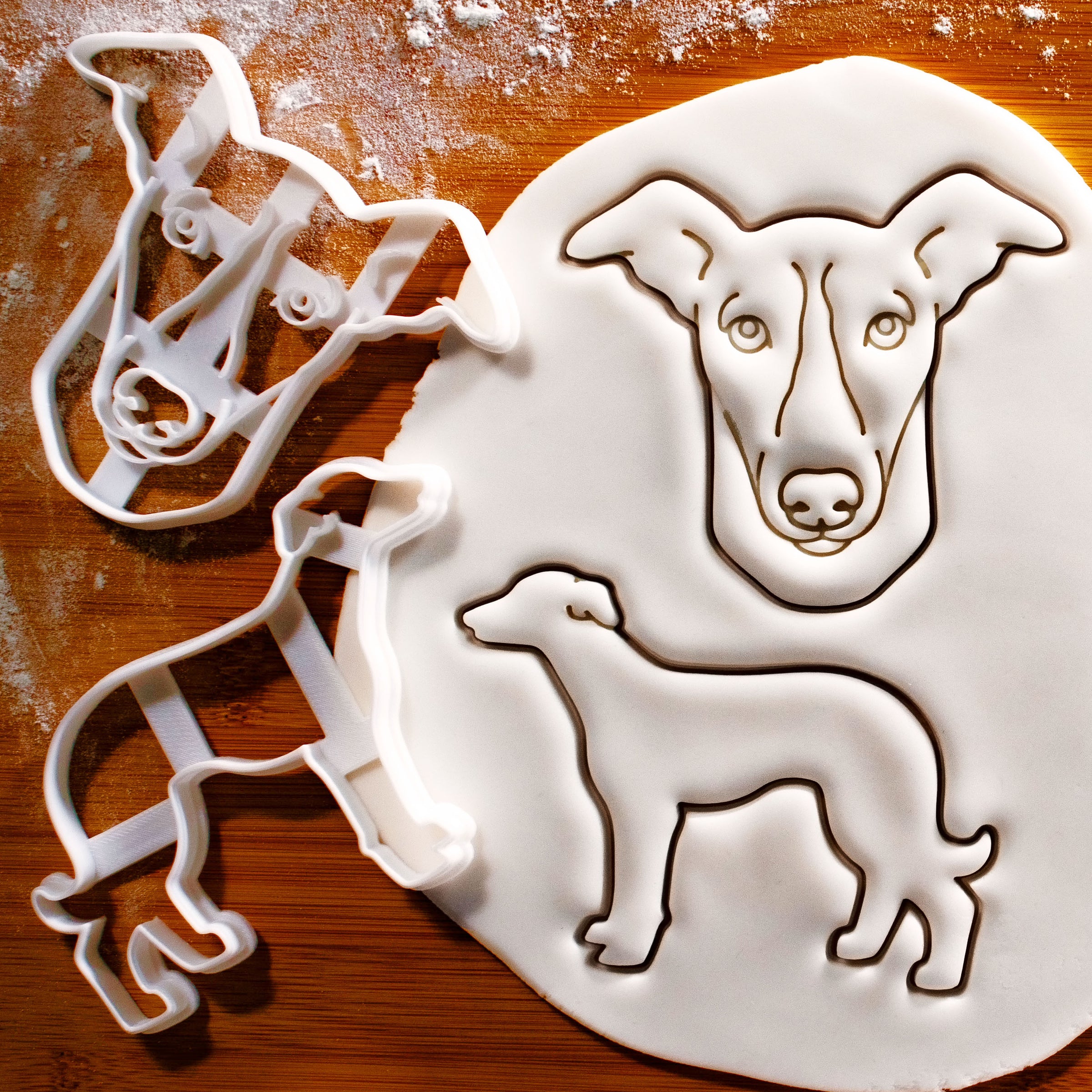 set of 2 whippet dog cookie cutters pressed onto white fondant icing to show imprints - Bakerlogy