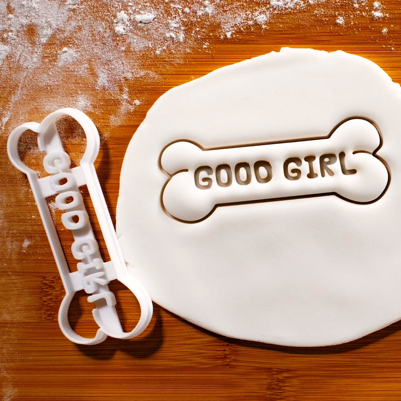 GOOD GIRL Dog Bone Cookie Cutter pressed on white fondant icing to show imprints - Bakerlogy