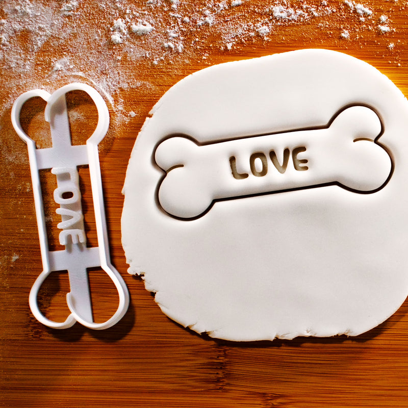 LOVE Dog Bone Cookie Cutter pressed on white fondant icing to show imprints - Bakerlogy
