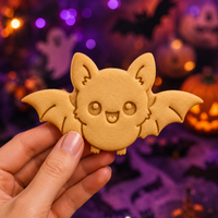 Flying chibi bat cookie with detailed wings and cute face for a kawaii Halloween party