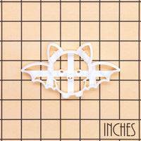 Flying Chibi Bat Cookie Cutter shown on an inch measurement grid for size reference