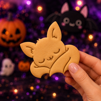Sleeping chibi bat cookie with folded wings for a cute gothic Halloween party