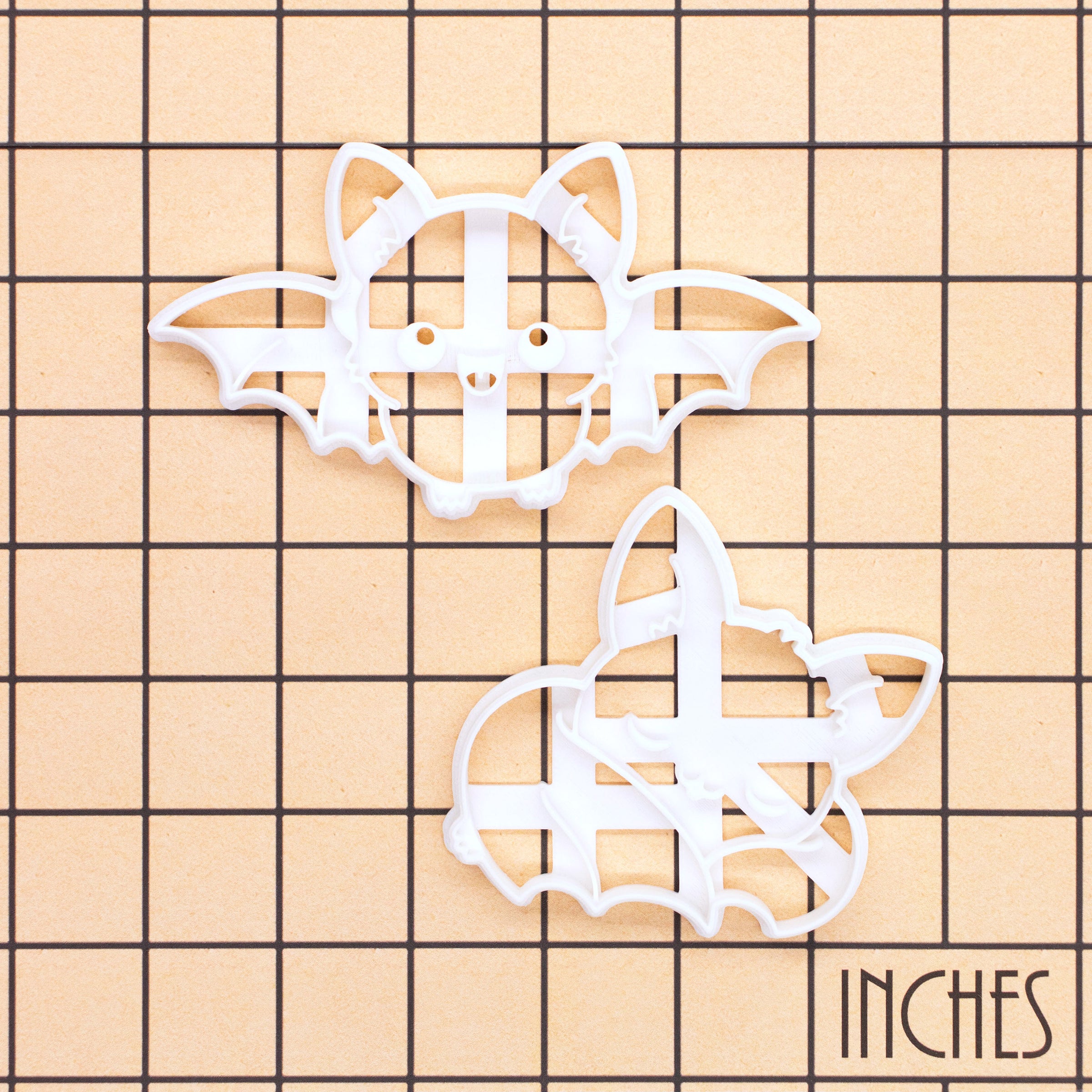 Flying and Sleeping Chibi Bat Cookie Cutters shown together on an inch measurement grid