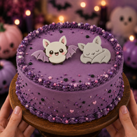 Flying and sleeping chibi bat fondant cake toppers on a purple kawaii Halloween cake