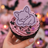 Purple sleeping chibi bat fondant cupcake topper with detailed stamp impression for spooky Halloween baking