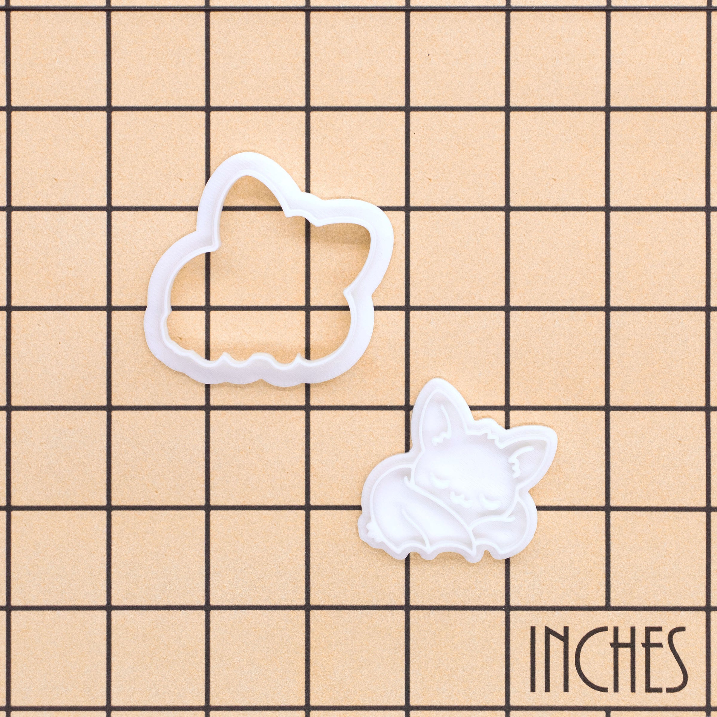 Sleeping Chibi Bat Mini Cookie Cutter and separate stamp shown on an inch measurement grid for size reference