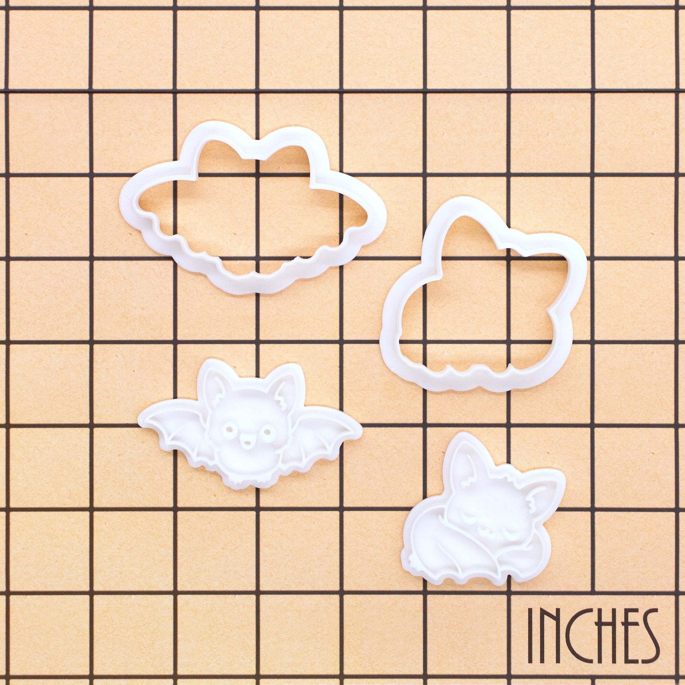 Flying and Sleeping Chibi Bat Mini Cookie Cutter and Stamp Sets shown on an inch measurement grid for size reference