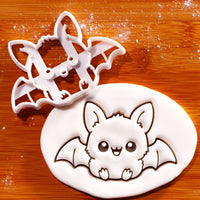 Sitting chibi bat cookie cutter creating a cute embossed bat with wings and tiny fangs for Halloween baking