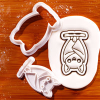 Hanging chibi bat mini cookie cutter and stamp with upside-down bat impression embossed in fondant
