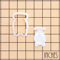 Hanging chibi bat mini cookie cutter and stamp shown on an inch measurement grid for size reference