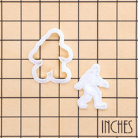 Bigfoot mini cookie cutter and stamp shown on an inch measurement grid