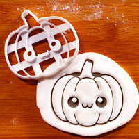 Kawaii pumpkin cookie cutter beside detailed smiling pumpkin impression in white fondant