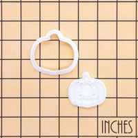 Kawaii pumpkin mini cookie cutter and stamp set shown on an inch measurement grid