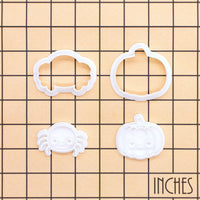 Chibi spider and kawaii pumpkin mini cookie cutter and stamp sets on an inch grid