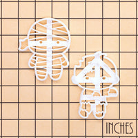Chibi mummy and zombie cookie cutter set shown on inch measurement grid