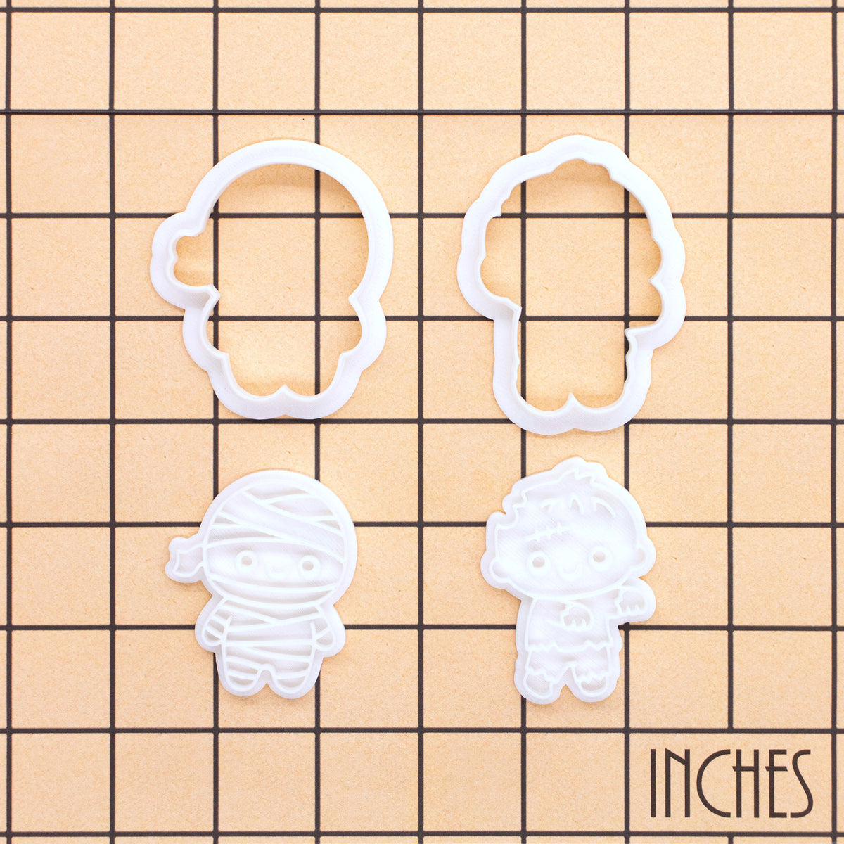 Chibi mummy and zombie mini cookie cutter and stamp sets on inch measurement grid