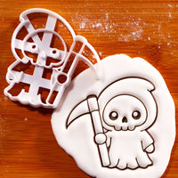 Kawaii Grim Reaper cookie cutter with fondant impression on wooden board