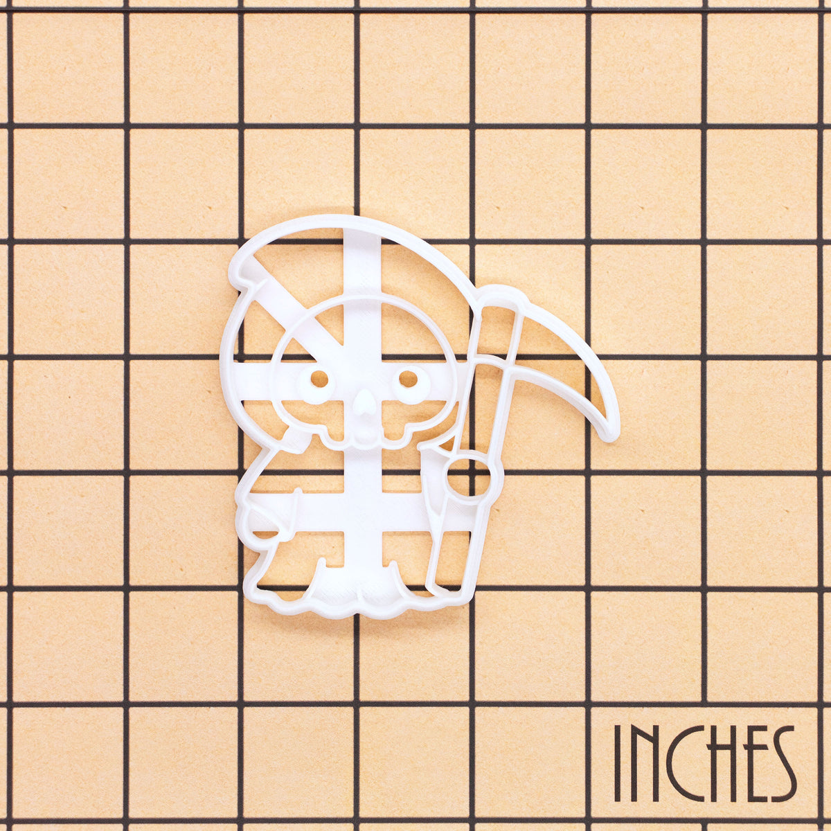 Kawaii Grim Reaper cookie cutter on inch grid size guide