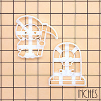 Grim Reaper and RIP Tombstone with Skull Halloween cookie cutters shown on inch measurement grid