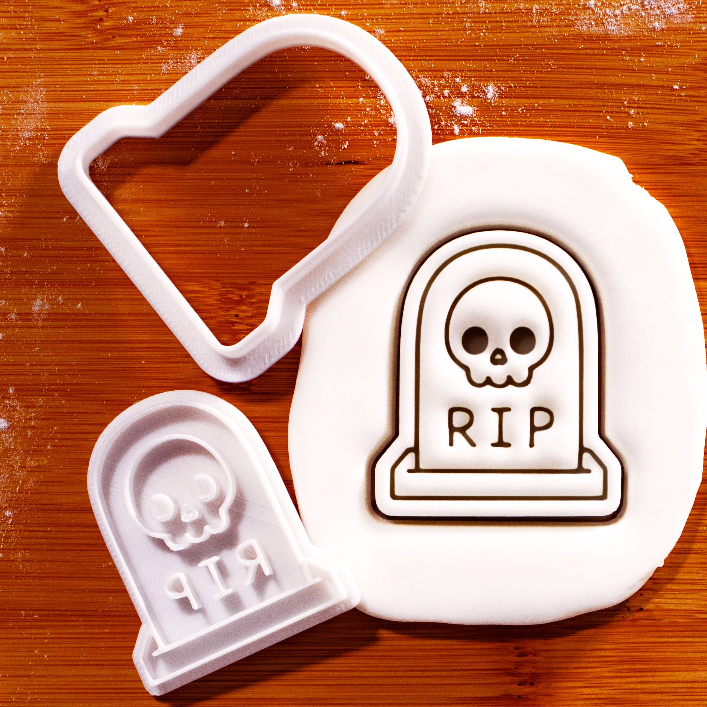 Tombstone with Skull mini cookie cutter and stamp set with fondant impression on a wooden board