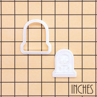 Tombstone with Skull mini cookie cutter and separate stamp shown on an inch measurement grid