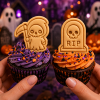 Grim Reaper and RIP tombstone cookie toppers on Halloween cupcakes with purple and orange frosting
