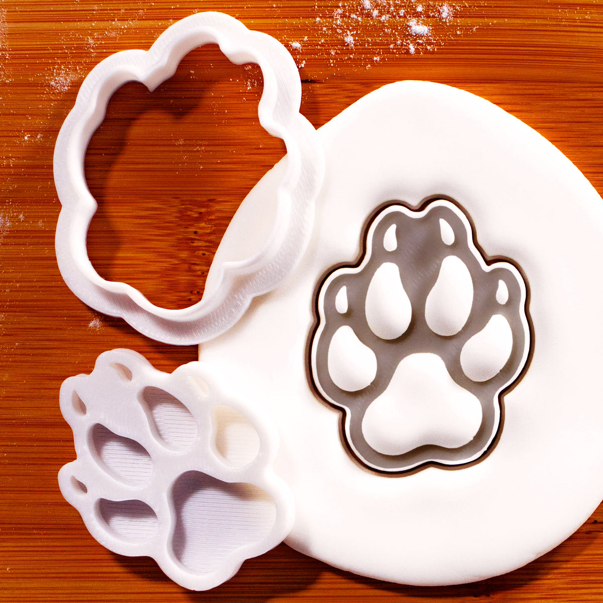 Wolf Paw Print mini cookie cutter and stamp with fondant impression on wooden board