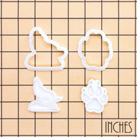 Howling Wolf and Wolf Paw Print mini cutters and stamps shown on inch measurement grid
