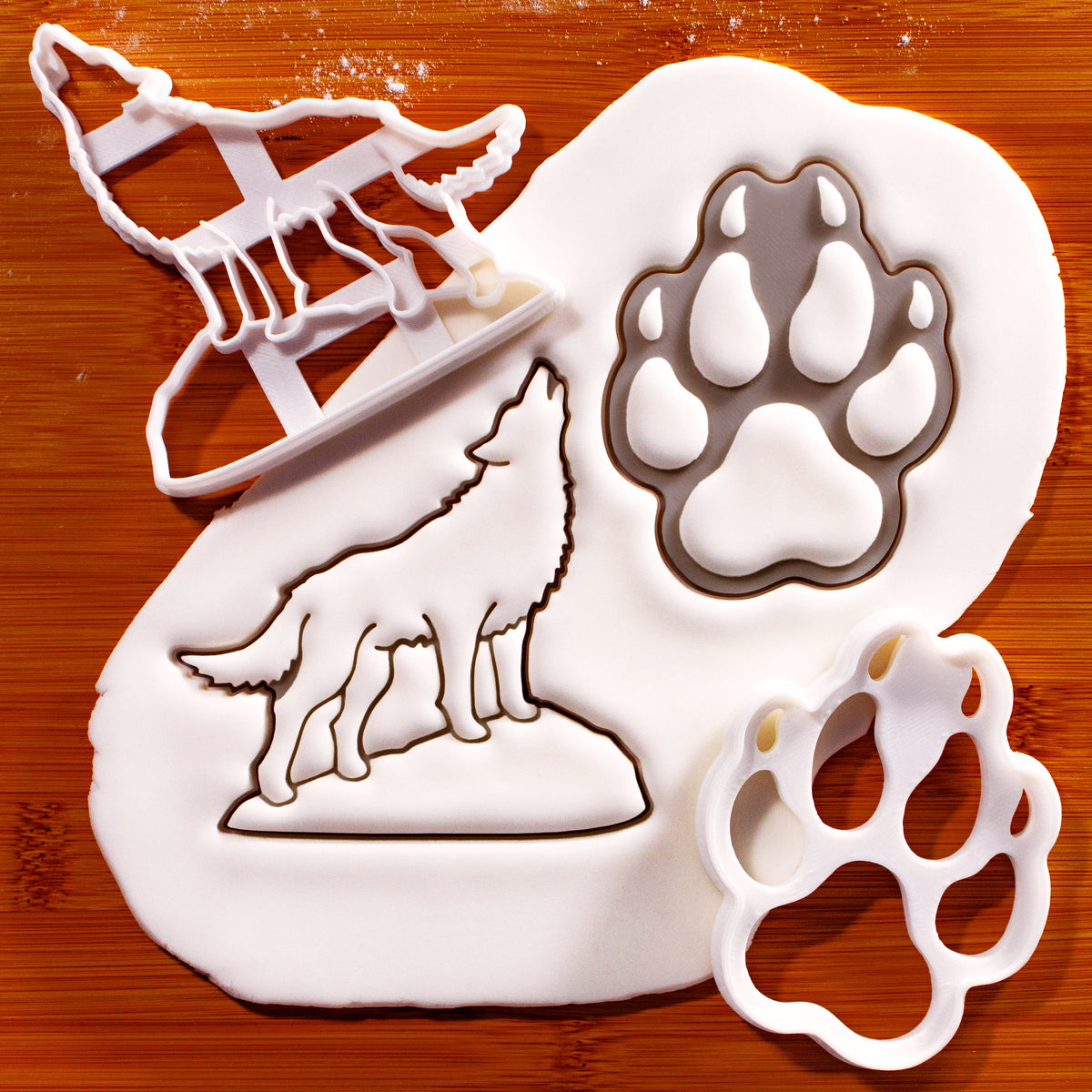 Howling wolf and wolf paw print cookie cutters with detailed fondant impressions