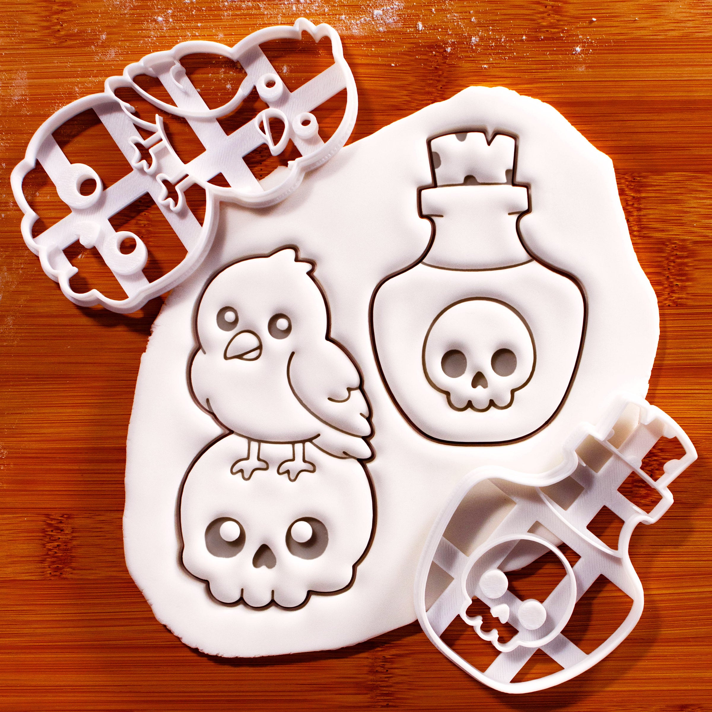 Kawaii raven on skull and poison potion Halloween cookie cutters with fondant impressions