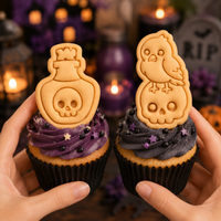 Raven on skull and poison potion mini Halloween cookies used as spooky cupcake toppers