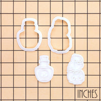 Raven on skull and poison potion mini cookie cutters and stamps shown on an inch measurement grid