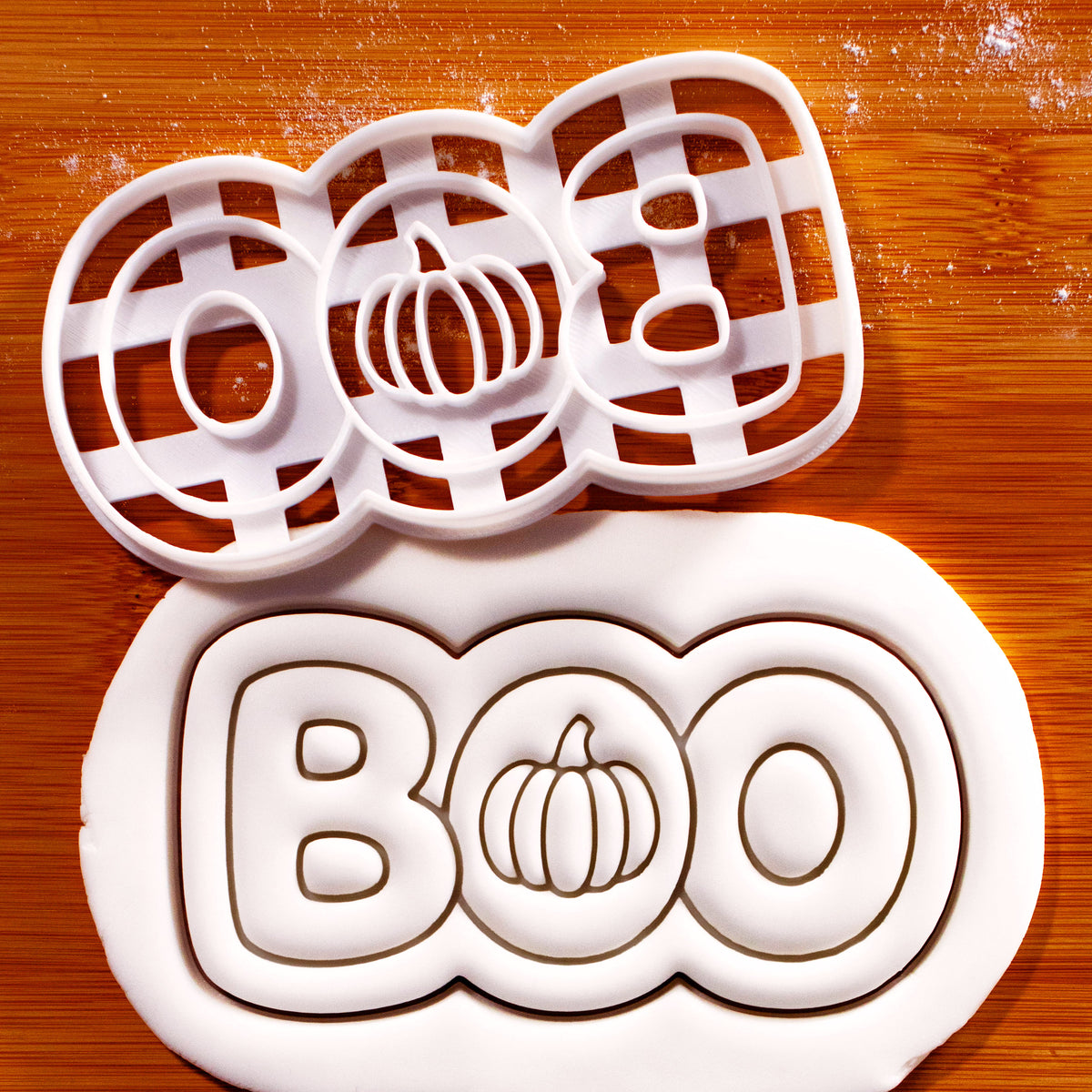 BOO pumpkin Halloween cookie cutter with embossed pumpkin lettering shown in rolled fondant