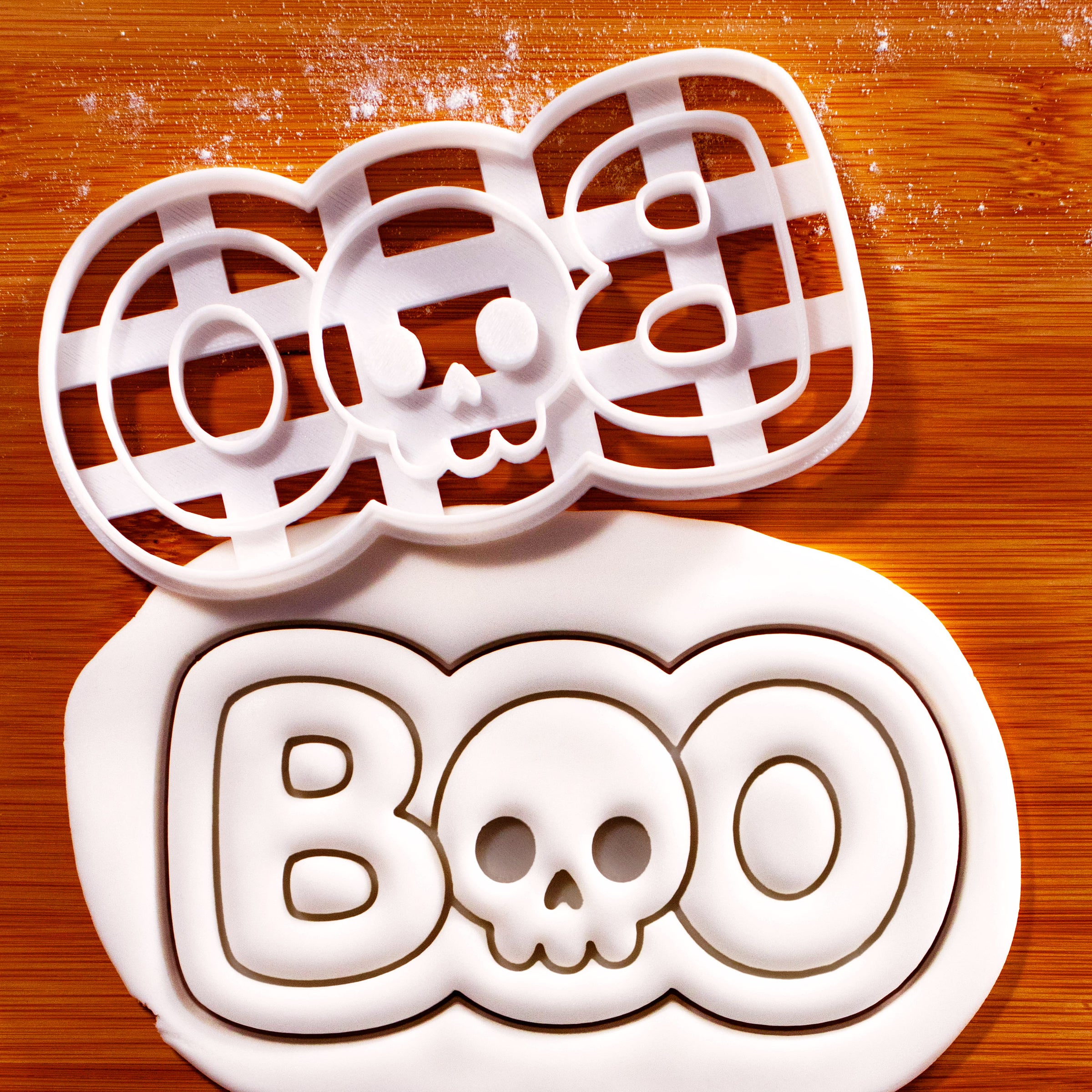 BOO skull cookie cutter beside embossed fondant showing Halloween skull lettering design