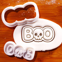BOO skull mini cookie cutter and stamp set with fondant impression on wooden board