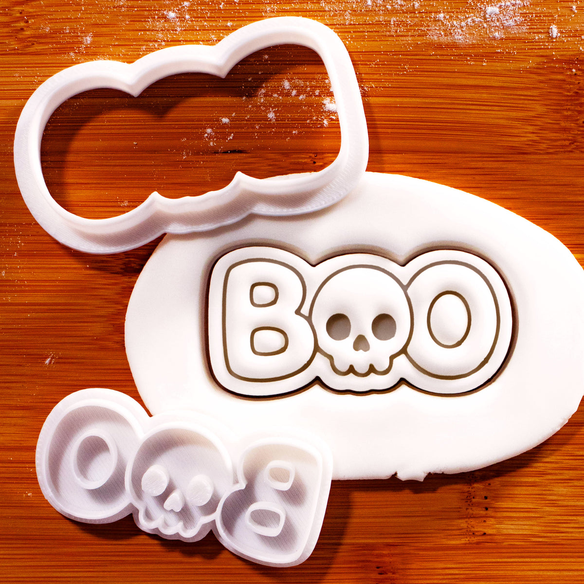 BOO skull mini cookie cutter and stamp set with fondant impression on wooden board