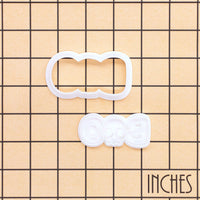 BOO skull mini cookie cutter and matching stamp set shown on inch measurement grid