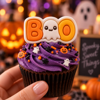 BOO cute ghost fondant cupcake topper on a purple Halloween cupcake with sprinkles and spooky background