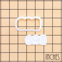 BOO Cute Ghost mini cookie cutter and stamp set on an inch grid showing the size of the Halloween baking tool