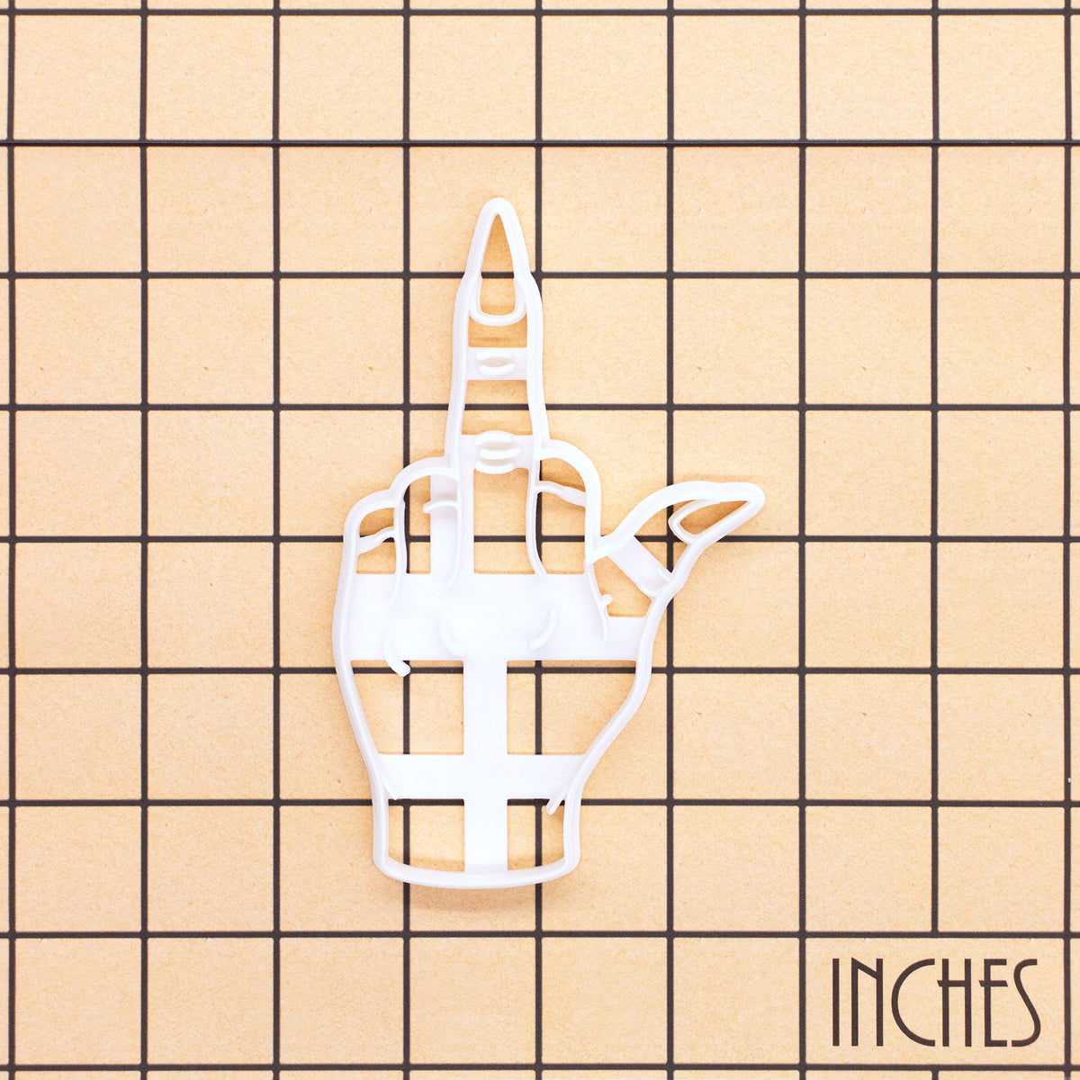 Witchy middle finger Halloween cookie cutter shown on an inch measurement grid