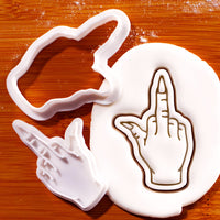 Witchy middle finger mini cookie cutter and stamp set beside detailed hand impression in fondant