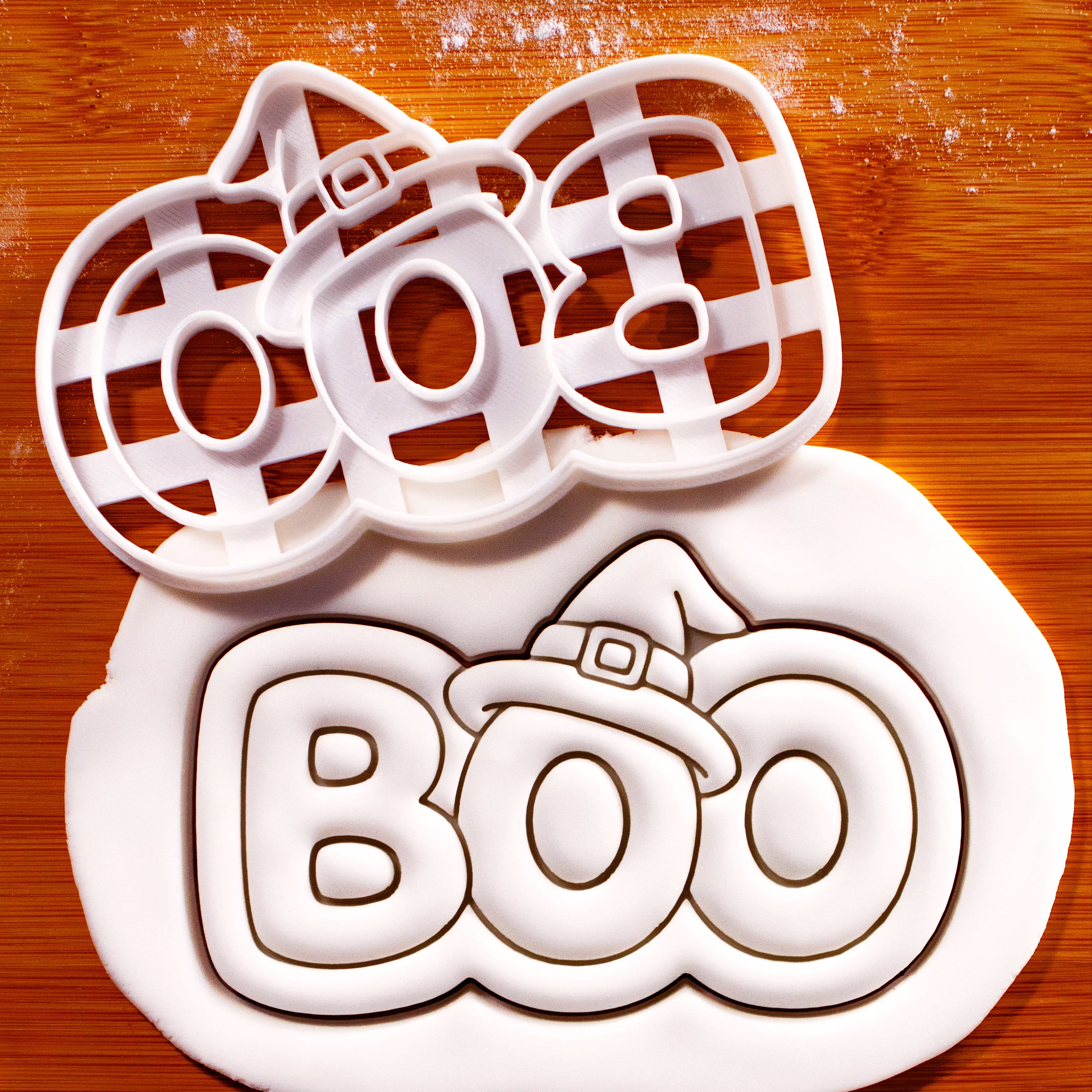 BOO witch hat Halloween cookie cutter beside detailed BOO fondant impression with witch hat and buckle