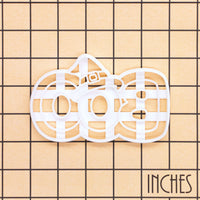 BOO witch hat cookie cutter shown on inch measurement grid for size reference