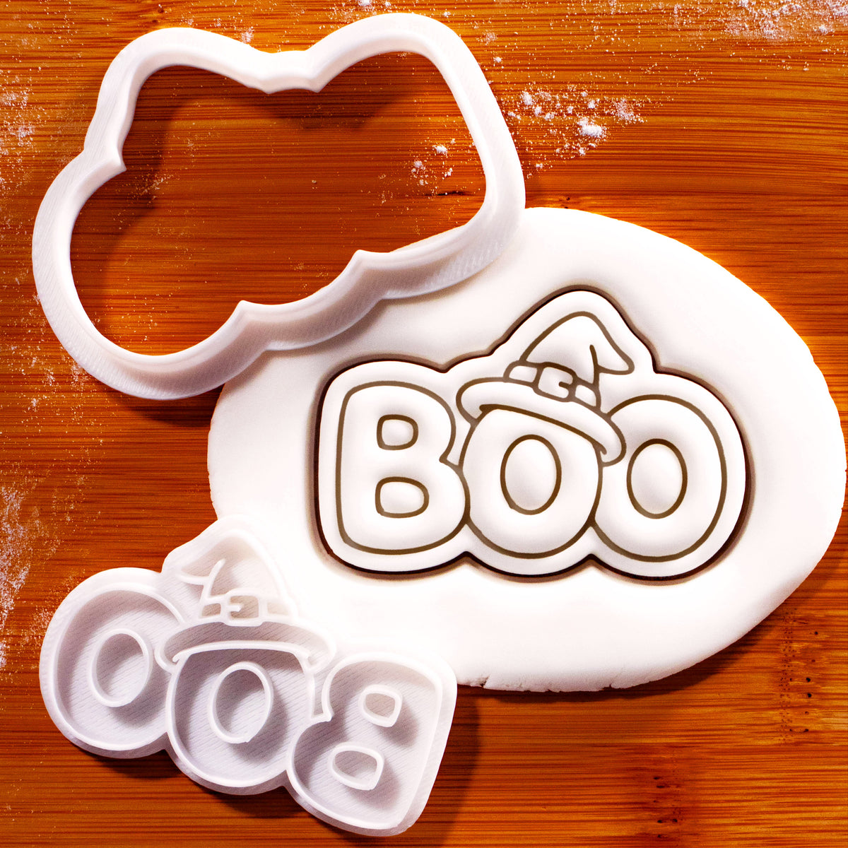 BOO witch hat mini cookie cutter and separate stamp beside detailed fondant impression