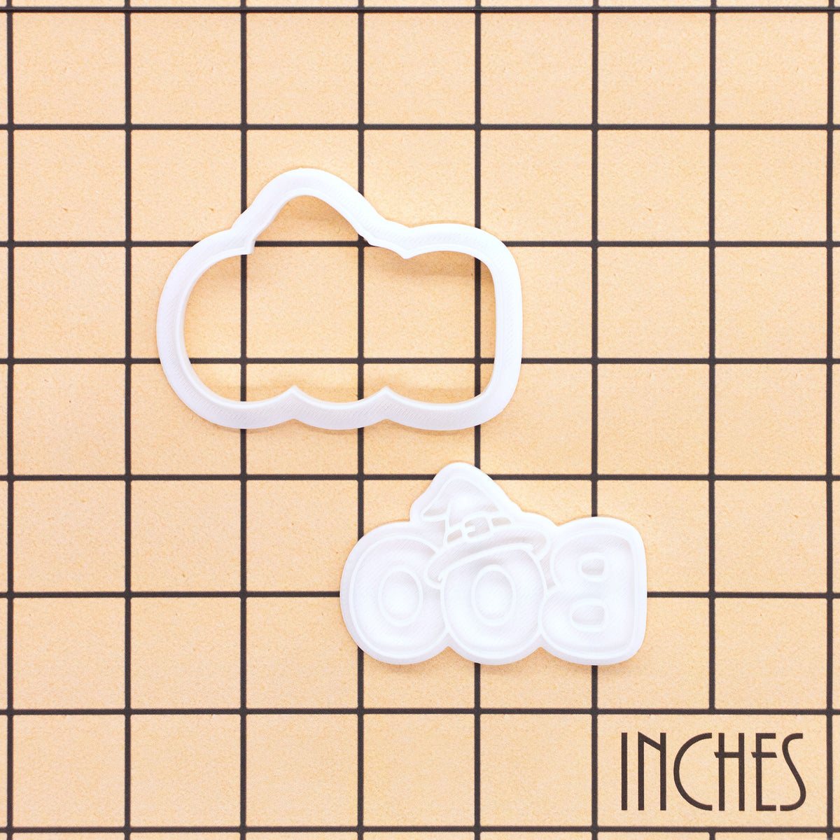 BOO witch hat mini cookie cutter and impression stamp shown on inch measurement grid