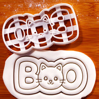 BOO cat face cookie cutter beside stamped fondant showing detailed cat face and BOO lettering