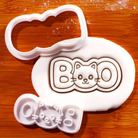 BOO cat face mini cookie cutter and stamp set beside fondant impression on wooden board