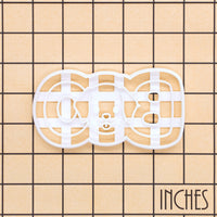 BOO dog face cookie cutter shown on inch measurement grid for size reference